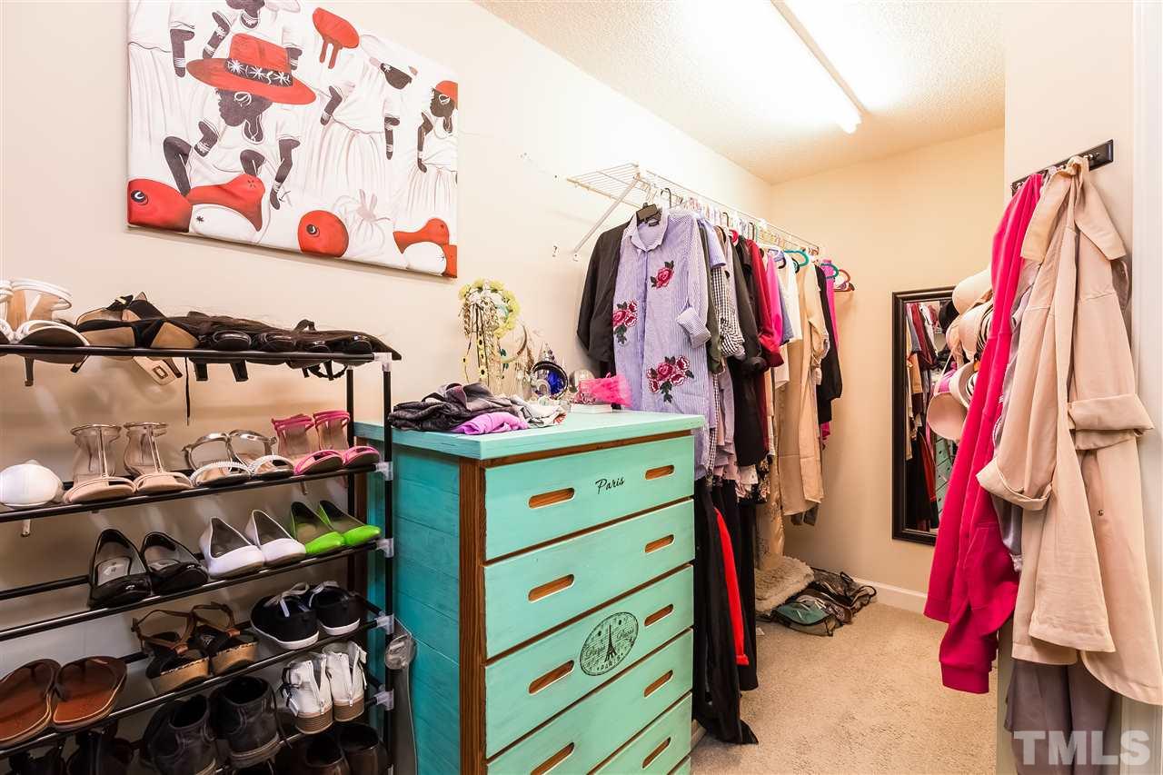 4201 Chelsford Place Raleigh, NC 27604 - Photo 16 of 24 a view of walk in closet with clothes and shoes