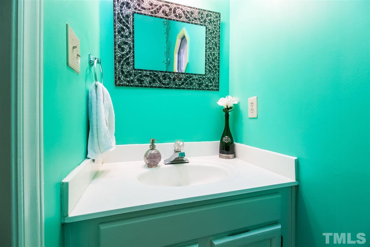 4201 Chelsford Place Raleigh, NC 27604 - Photo 10 of 24 a bathroom with a sink and a mirror