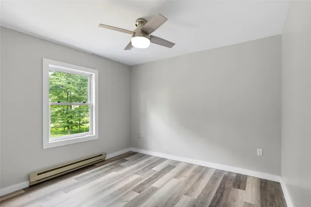 wooden floor in an empty room with a window