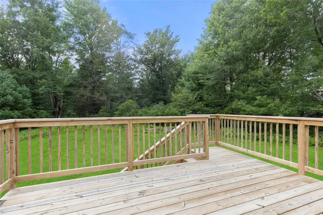 a view of balcony with wooden floor and fence