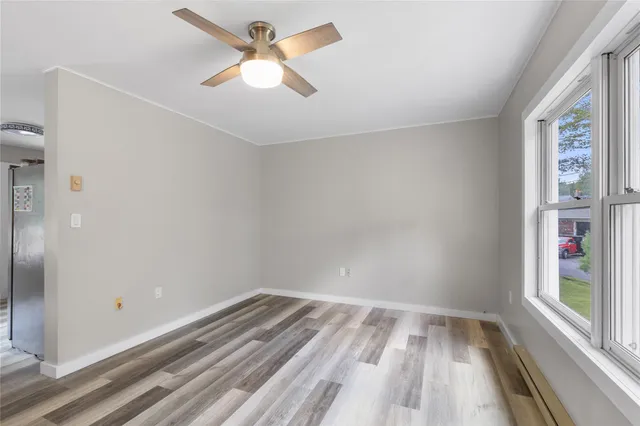 wooden floor in an empty room with a window