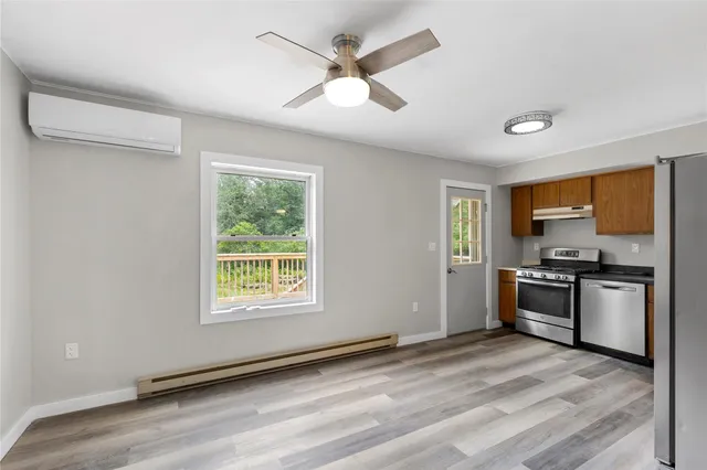 a kitchen with stainless steel appliances granite countertop a stove and a refrigerator