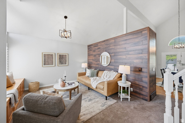3732 Campbell Road Tooele, UT 84074 - Photo 10 of 69 Spacious living area featuring a vaulted ceiling and a wood-panel accent wall
