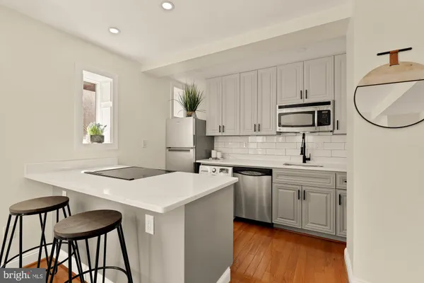 a kitchen with a stove a sink and a refrigerator