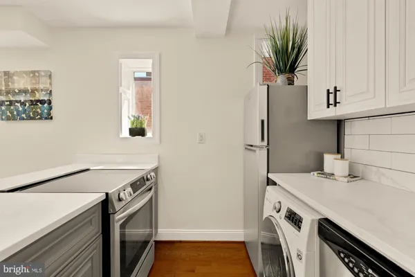 a kitchen with a sink and a refrigerator