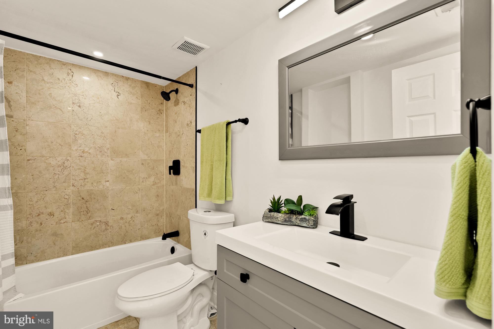 1125 12th Street Northwest, Unit 31 Washington, DC 20005 - Photo 20 of 25 a bathroom with a sink a toilet and shower