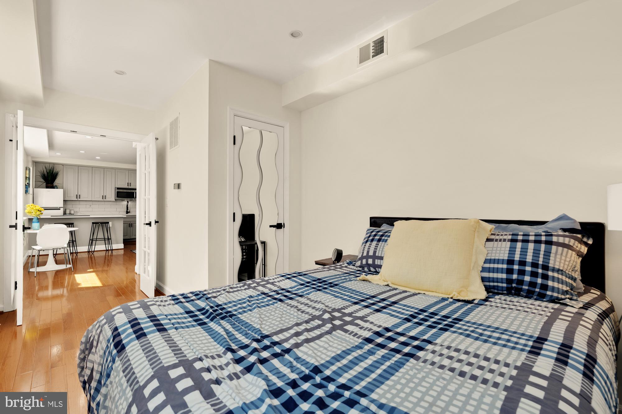 1125 12th Street Northwest, Unit 31 Washington, DC 20005 - Photo 23 of 25 a bedroom with a bed and wooden floor