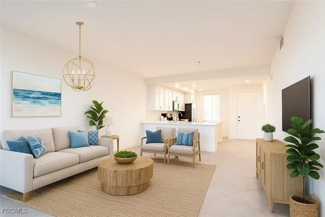 a living room with furniture a chandelier and a potted plant