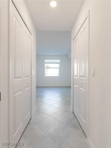 an empty room with an entryway and window