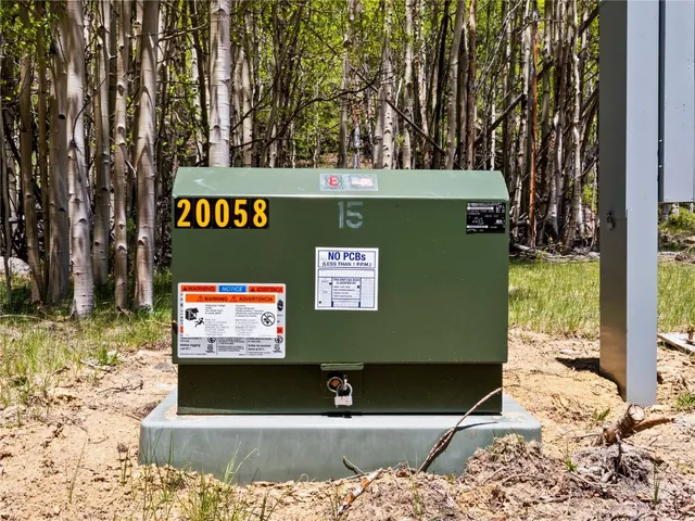 a view of a dry yard covered with snow in the background