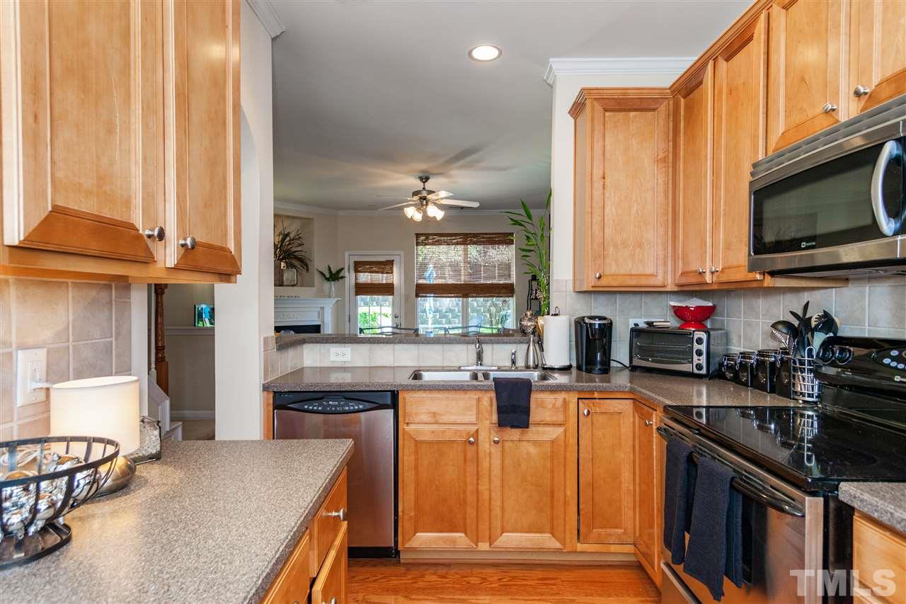 6014 Viking Drive Raleigh, NC 27612 - Photo 6 of 25 The kitchen is open to the family room. Beautiful cabinets. The corian counter tops are gorgeous.