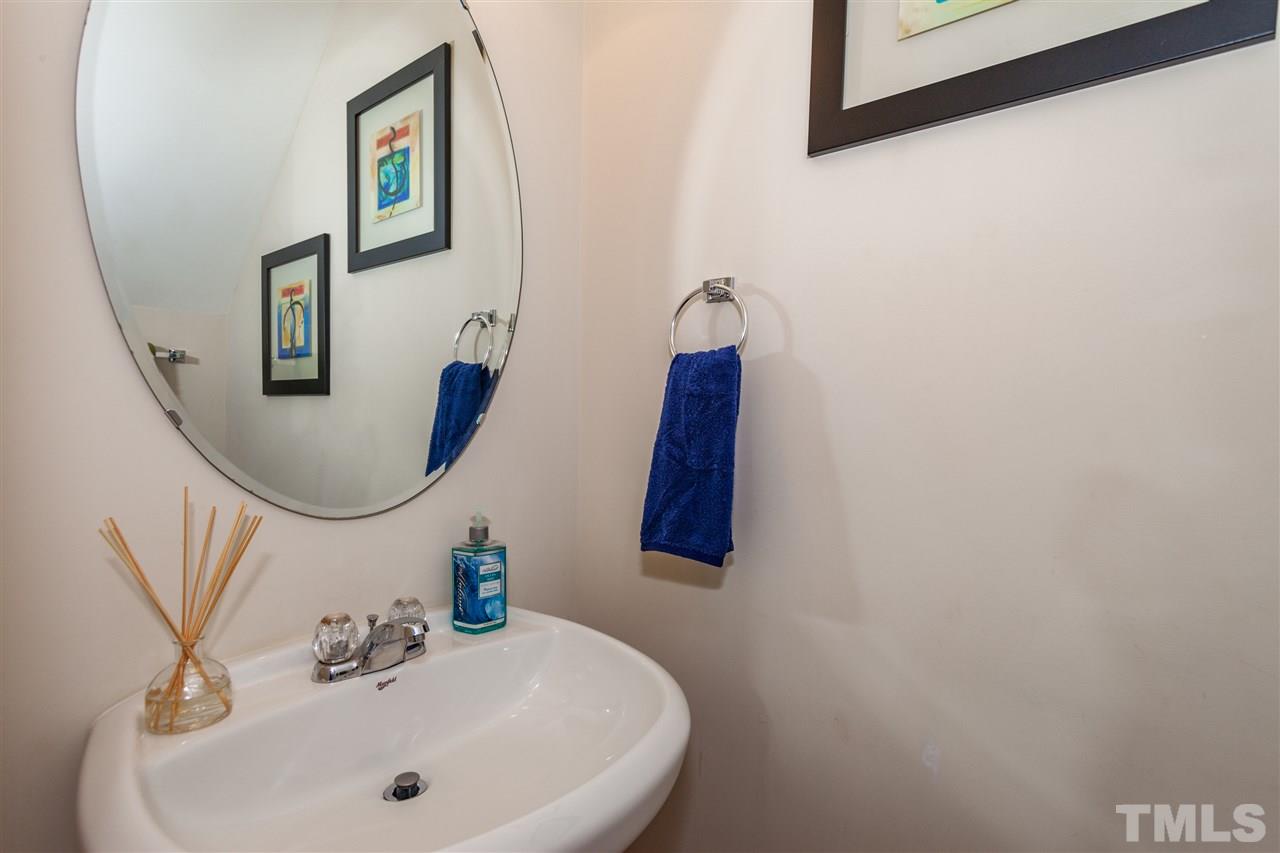 6014 Viking Drive Raleigh, NC 27612 - Photo 10 of 25 The powder room is conveniently located downstairs. Nice pedestal sink..