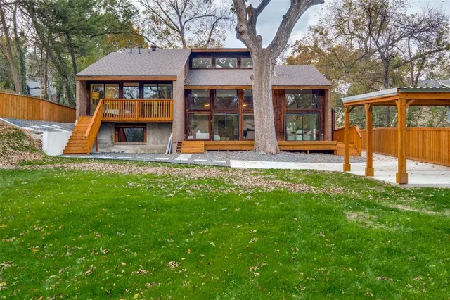 a view of a house with backyard porch and sitting area