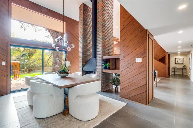 a view of a dining room with a table and chairs