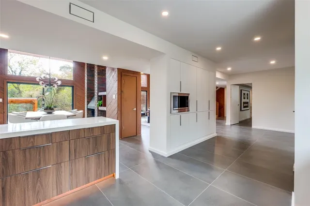 a spacious bedroom with a bed and large window
