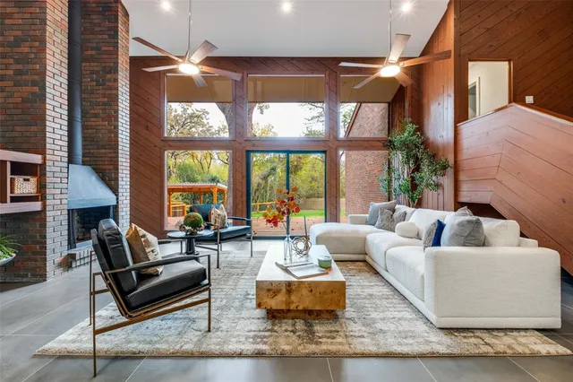 a living room with furniture and large windows