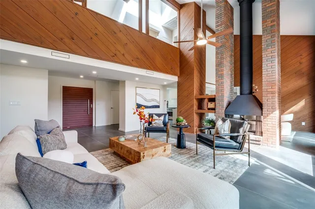 a living room filled with furniture and a large window