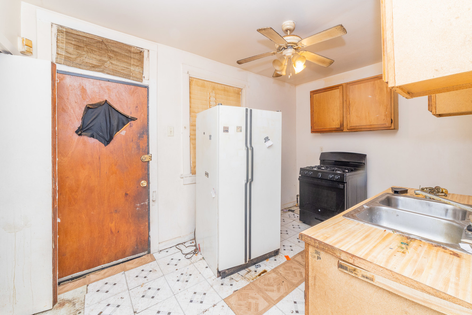 9154 South May Street Chicago, IL 60620 - Photo 14 of 40 a kitchen with a refrigerator and a sink