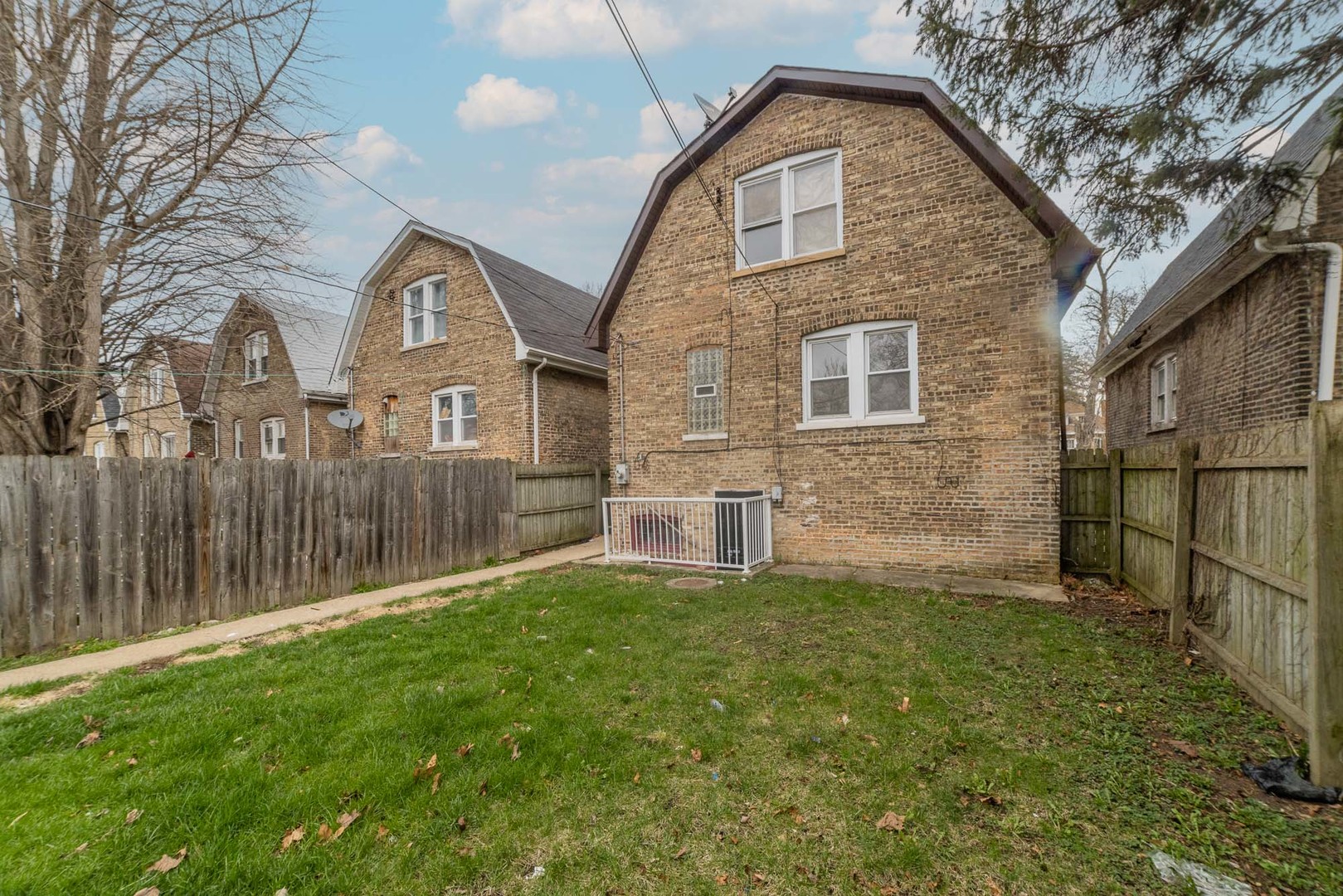 9154 South May Street Chicago, IL 60620 - Photo 38 of 40 a front view of a house with a yard and garage