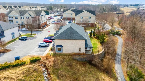 a view of a kitchen with wooden floor and a window
