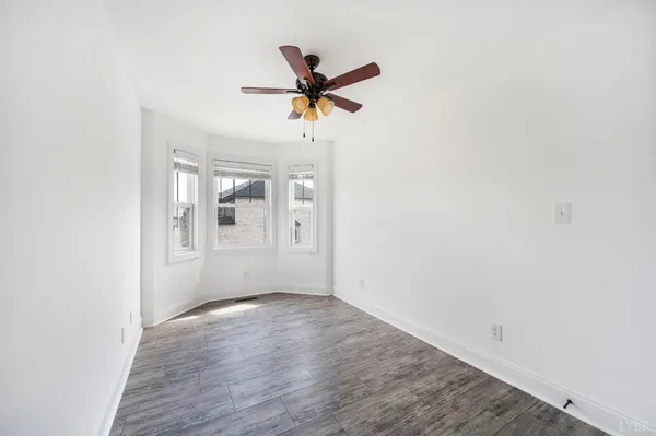 a kitchen with stainless steel appliances granite countertop a dishwasher a stove a sink dishwasher and a oven with wooden floor