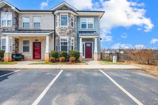 an empty room with wooden floor closet and windows