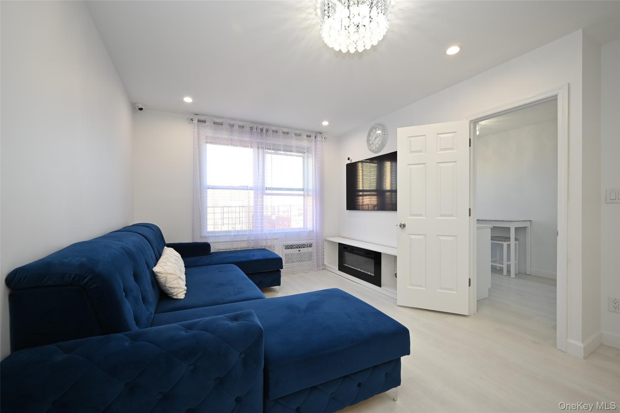100-25 Queens Boulevard, Unit 7M Queens, NY 11375 - Photo 6 of 16 a living room with furniture fireplace and flat screen tv