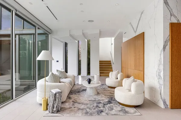 a kitchen with stainless steel appliances kitchen island granite countertop a table chairs and a view of living room