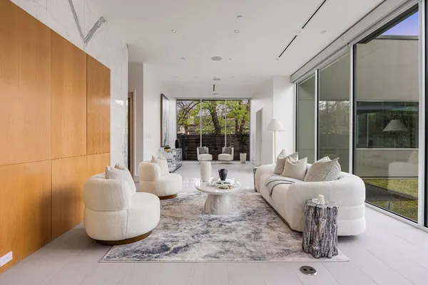 a large white kitchen with a large window