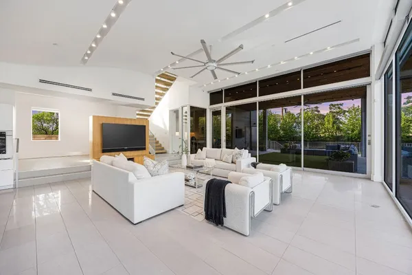 a living room with a flat screen tv and a floor to ceiling window