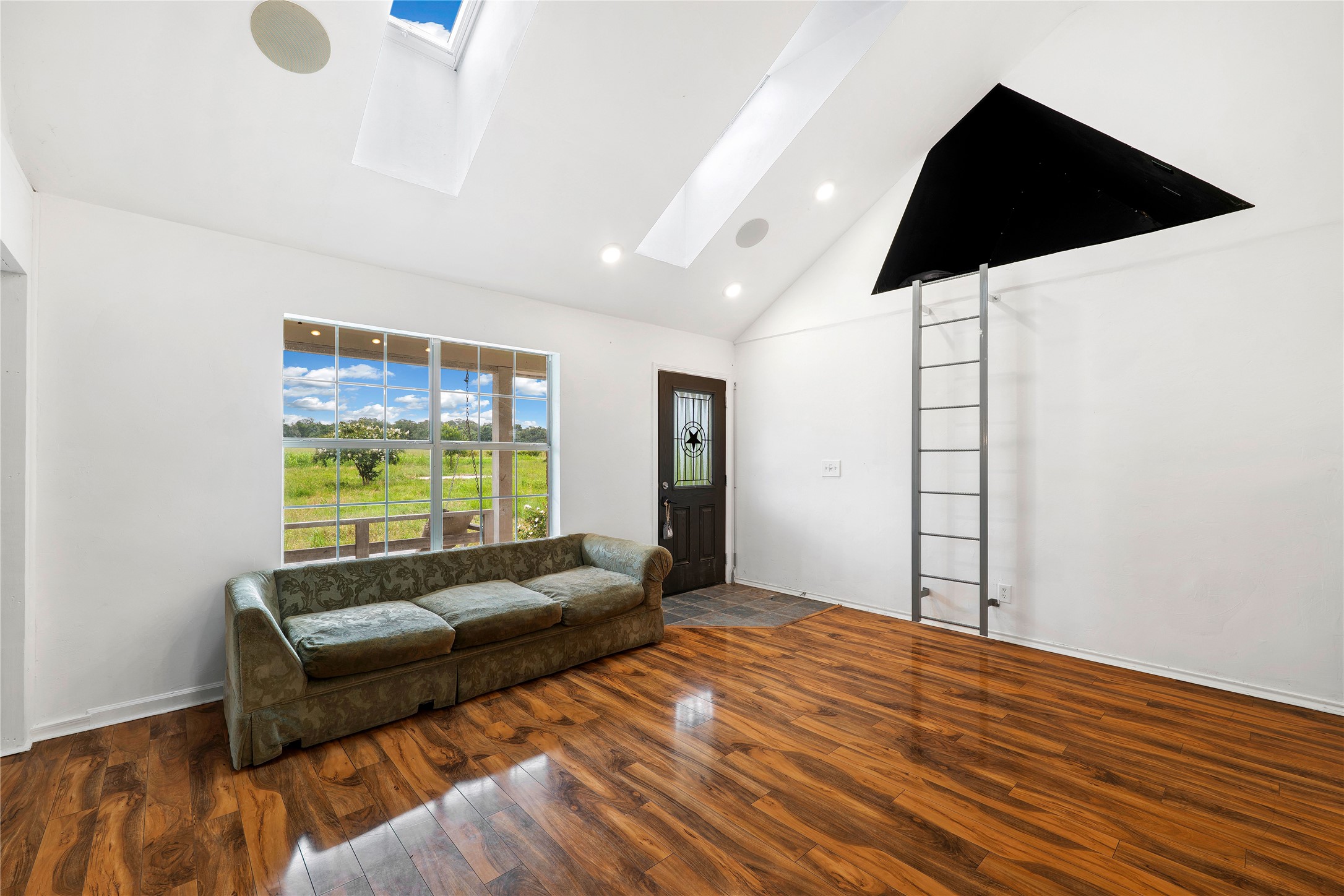 358 Easley Road Smithville, TX 78957 - Photo 4 of 36 Natural light floods this living area through generous windows and multiple skylights.