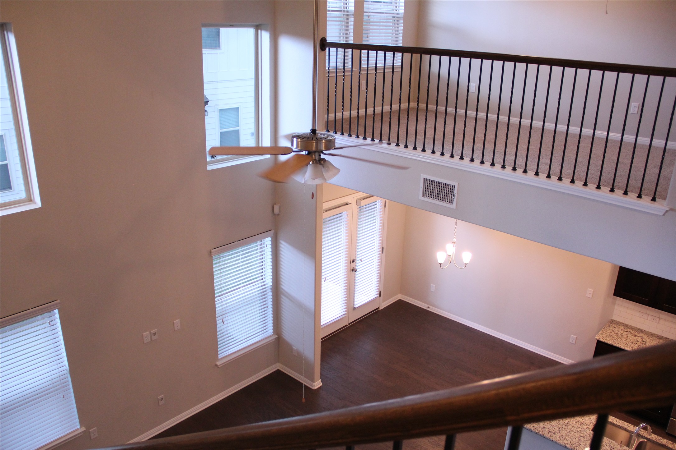 1612 Airedale Road Austin, TX 78748 - Photo 4 of 26 Stairway featuring ceiling fan, wood finished floors, and a high ceiling