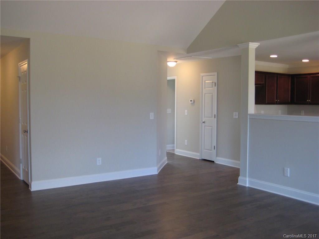 233 Springlake Road York, SC 29745 - Photo 3 of 21 an empty room with wooden floor and windows