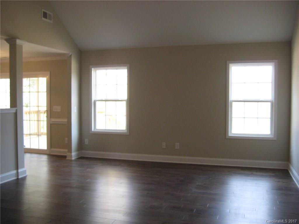 233 Springlake Road York, SC 29745 - Photo 8 of 21 an empty room with wooden floor and windows