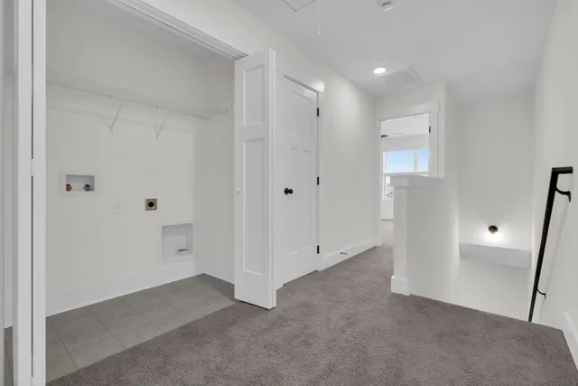 a view of a livingroom with wooden floor and staircase