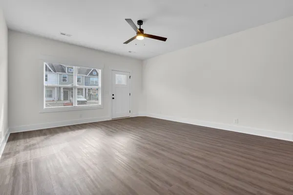 a view of kitchen with wooden floor and electronic appliances