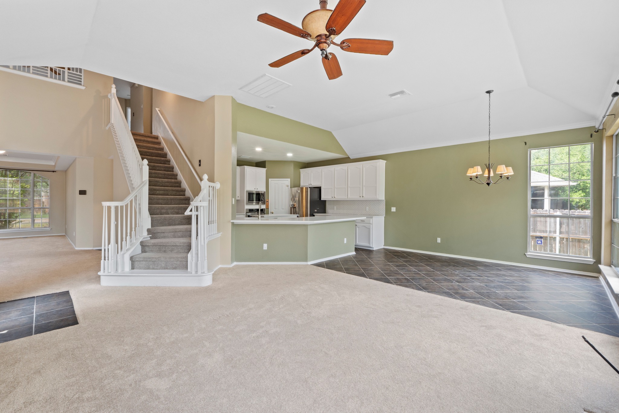 8605 Axis Drive Austin, TX 78749 - Photo 9 of 38 A spacious living area unfolds with a grand staircase and an open-concept kitchen.
