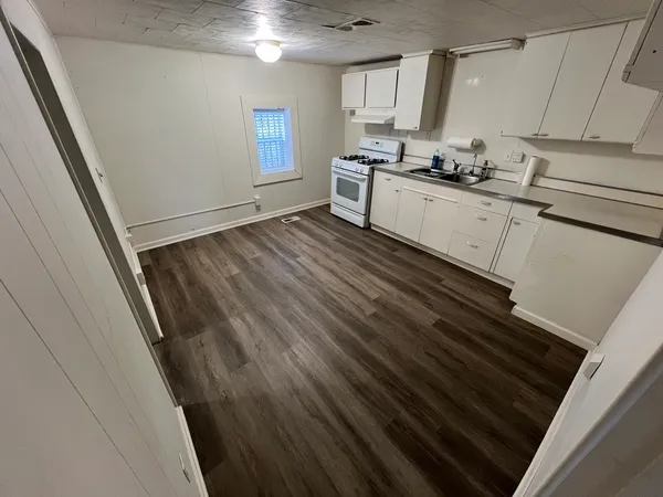 a kitchen with a sink stove and cabinets