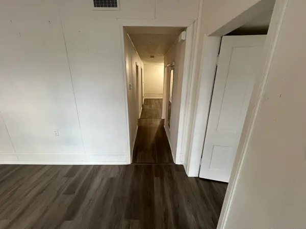 a view of a room with wooden floor and staircase