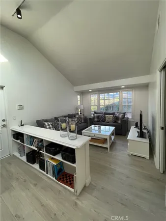 a living room with furniture and view of kitchen
