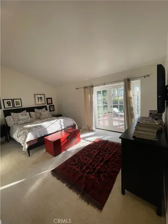 a large white kitchen with a sink and a large window