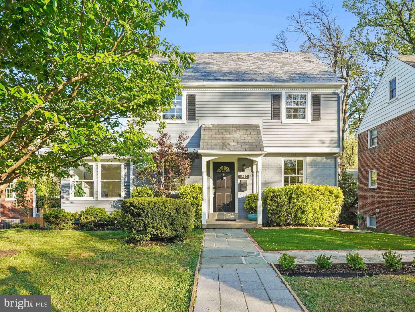 a front view of a house with a garden