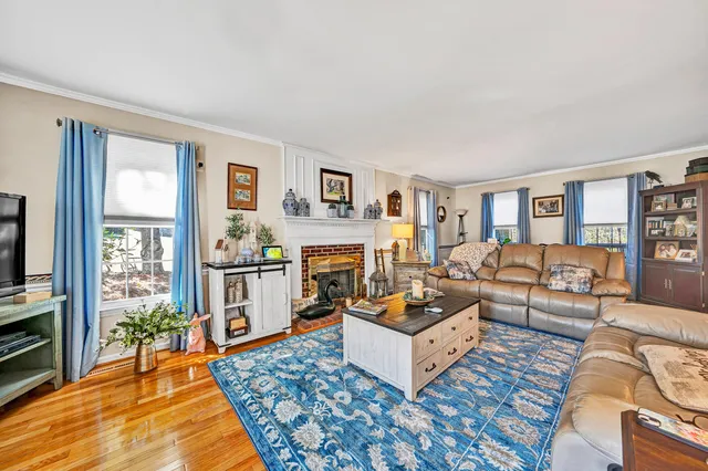 a living room with furniture a rug and a fireplace