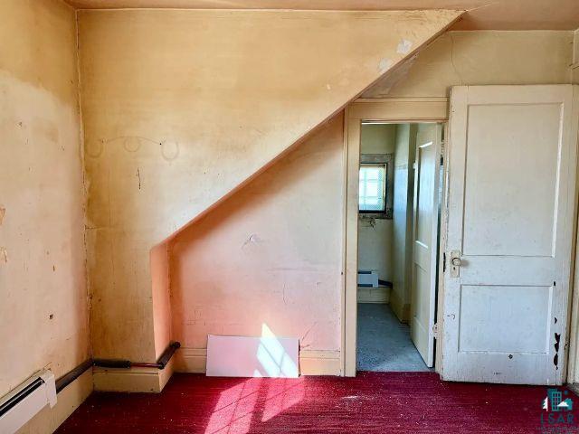 526 South 12th Street Virginia, MN 55792 - Photo 12 of 17 Bonus room with a baseboard heating unit and carpet flooring