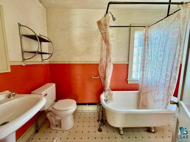 526 South 12th Street Virginia, MN 55792 - Photo 13 of 17 Bathroom featuring tile patterned floors and a combined bath / shower with freestanding tub
