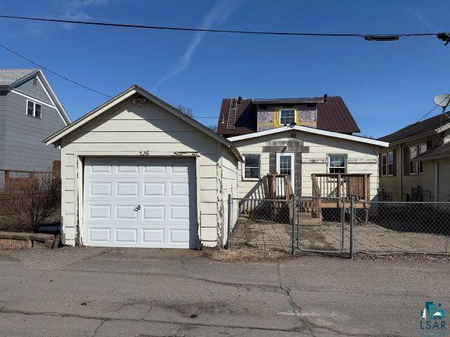 526 South 12th Street Virginia, MN 55792 - Photo 17 of 17 View of front of home with a gate, a fenced front yard, and an outdoor structure