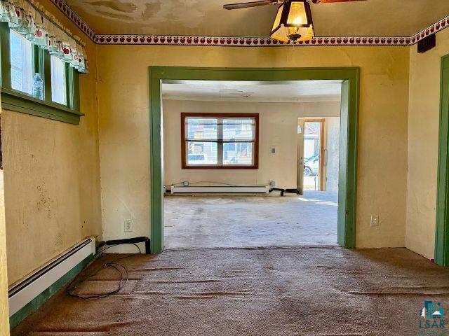 526 South 12th Street Virginia, MN 55792 - Photo 3 of 17 Hallway with a baseboard heating unit, carpet floors, and a baseboard radiator