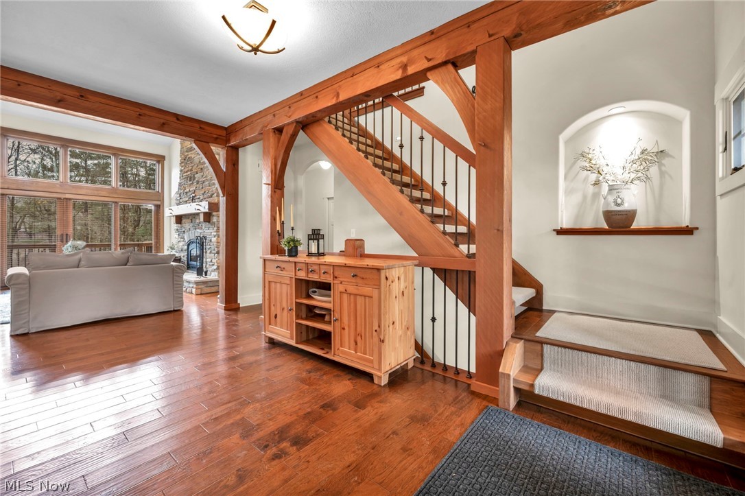11295 Sutton Place Chardon, OH 44024 - Photo 26 of 50 Staircase featuring hardwood / wood-style floors and a fireplace