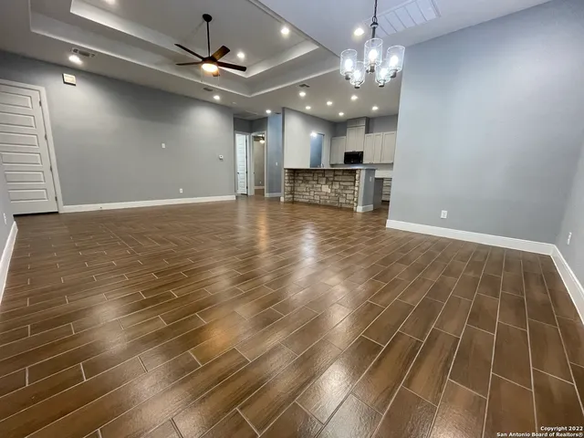 a view of a room with wooden floor