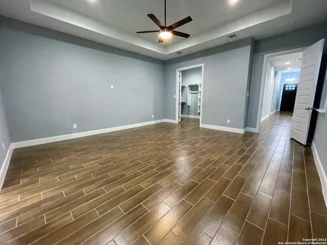 a view of empty room with wooden floor